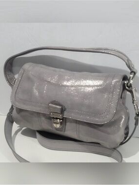 Coach Poppy Layla shimmery leather shoulder bag with a push-lock closure.